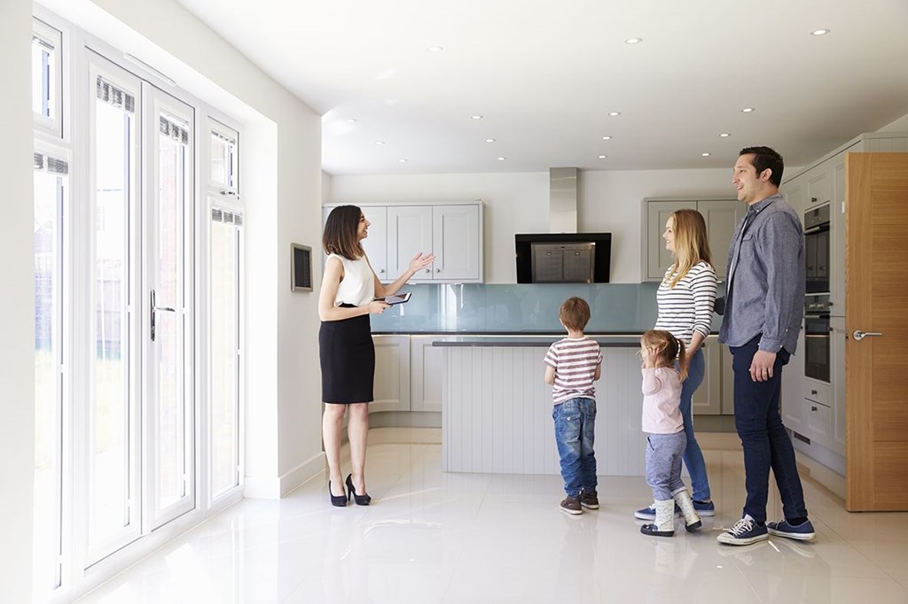 Real estate agent with a family in a kitchen